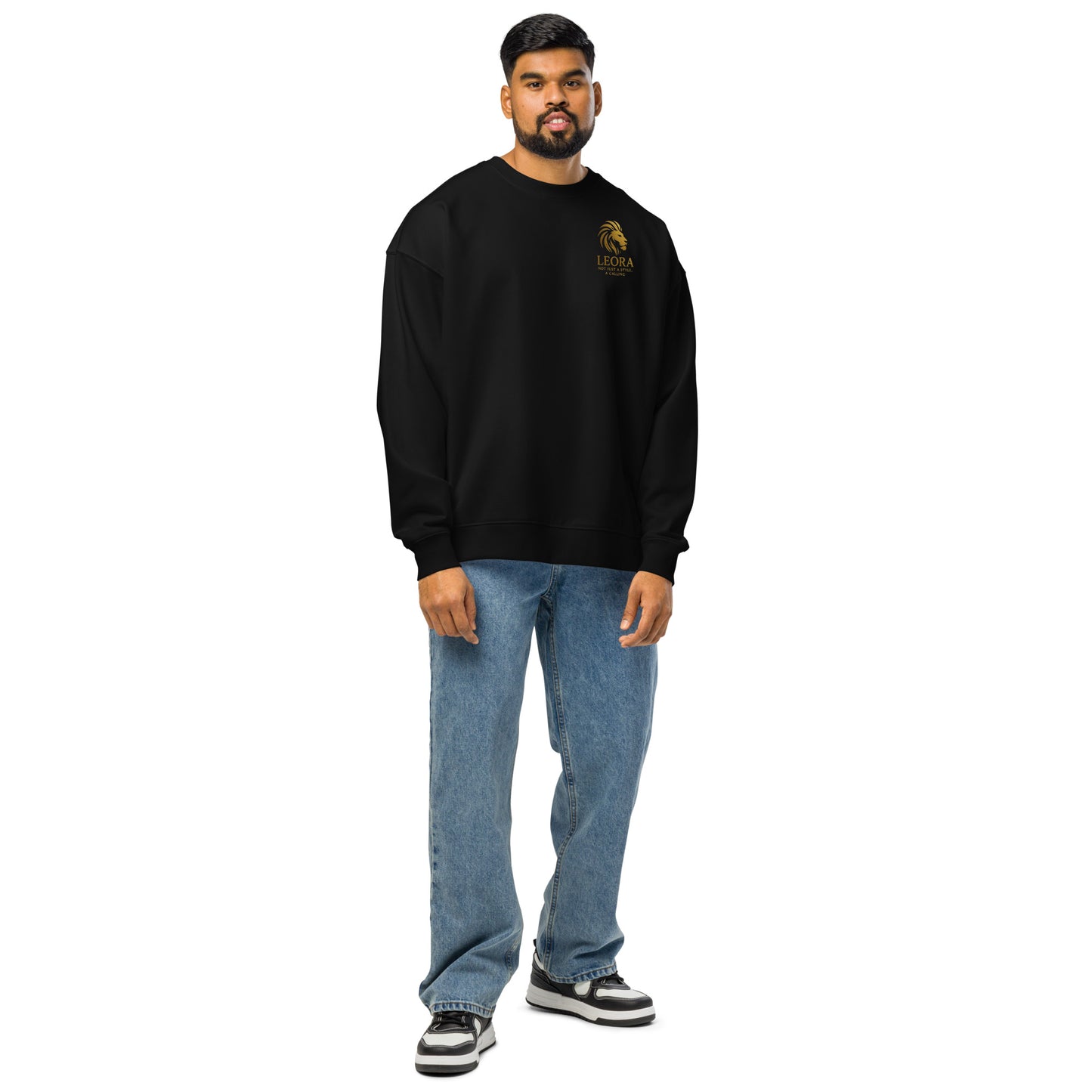 Man wearing a black oversized sweatshirt with gold crown and phoenix chest logo – eco-friendly motivational streetwear