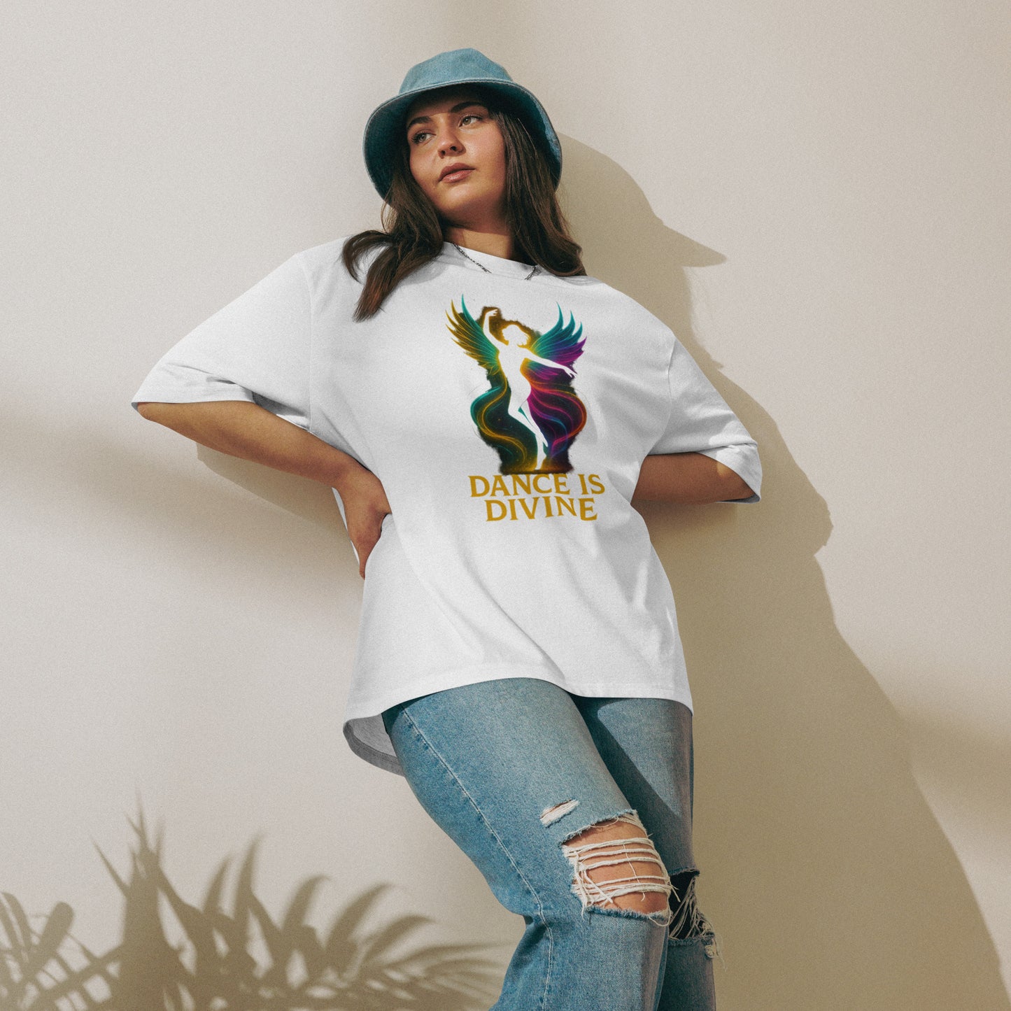 Woman wearing an oversized white t-shirt featuring a colorful dancing silhouette graphic – a blend of spiritual energy and relaxed streetwear
