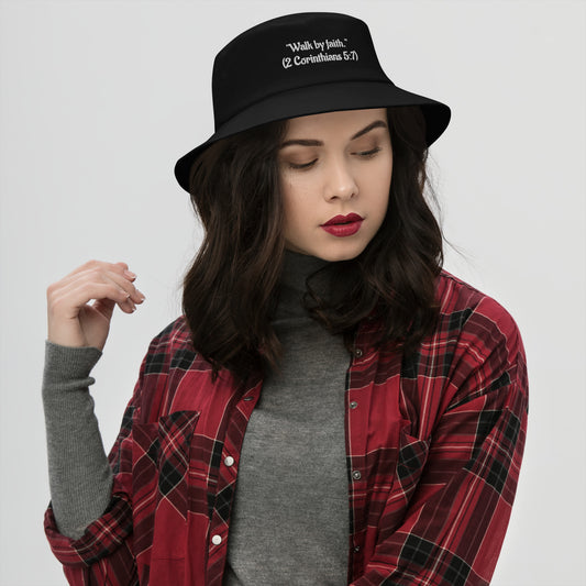 Woman wearing black Christian bucket hat with Walk by Faith embroidered on front
