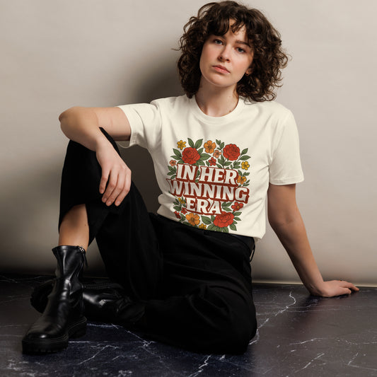 Women’s retro floral t-shirt with “Her Winning Era” design in bold text and floral accents.