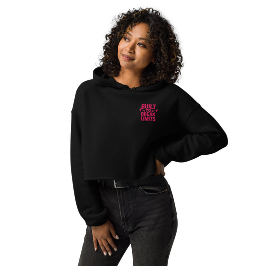 Woman wearing a black crop hoodie with bold flat embroidery and dropped shoulder fit
