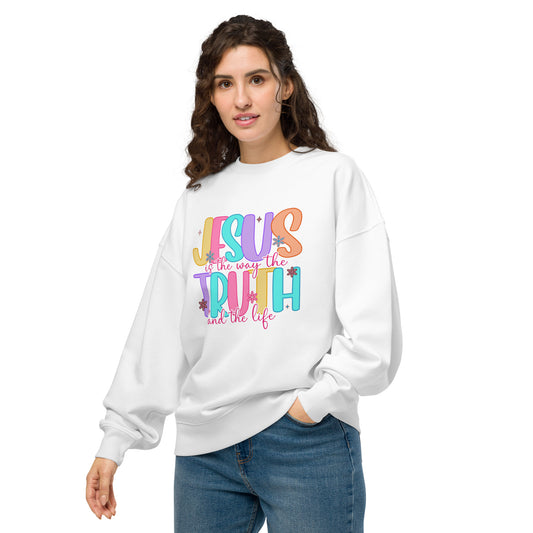 White oversized women’s sweatshirt with colorful “Jesus is the Way, the Truth, and the Life” text printed on front
