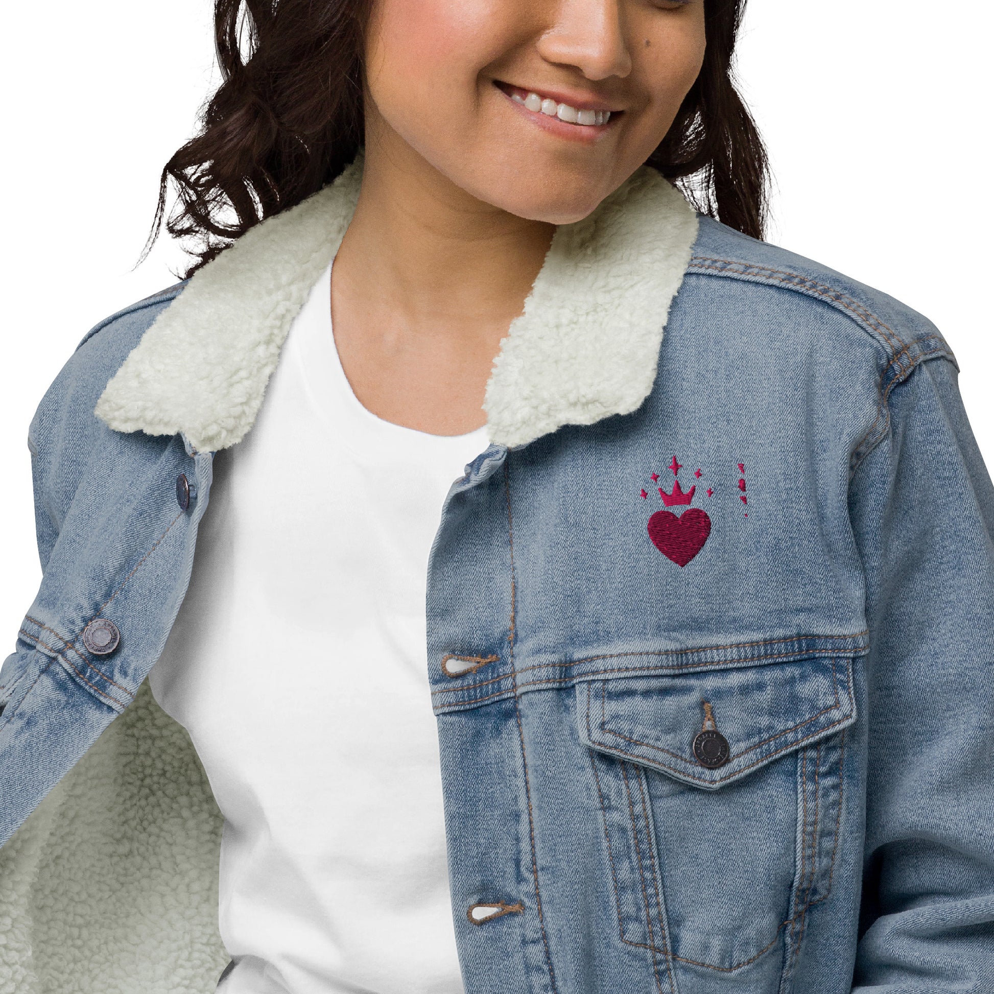 Woman wearing a sherpa-lined denim jacket with floral embroidery on the back and heart design on the front
