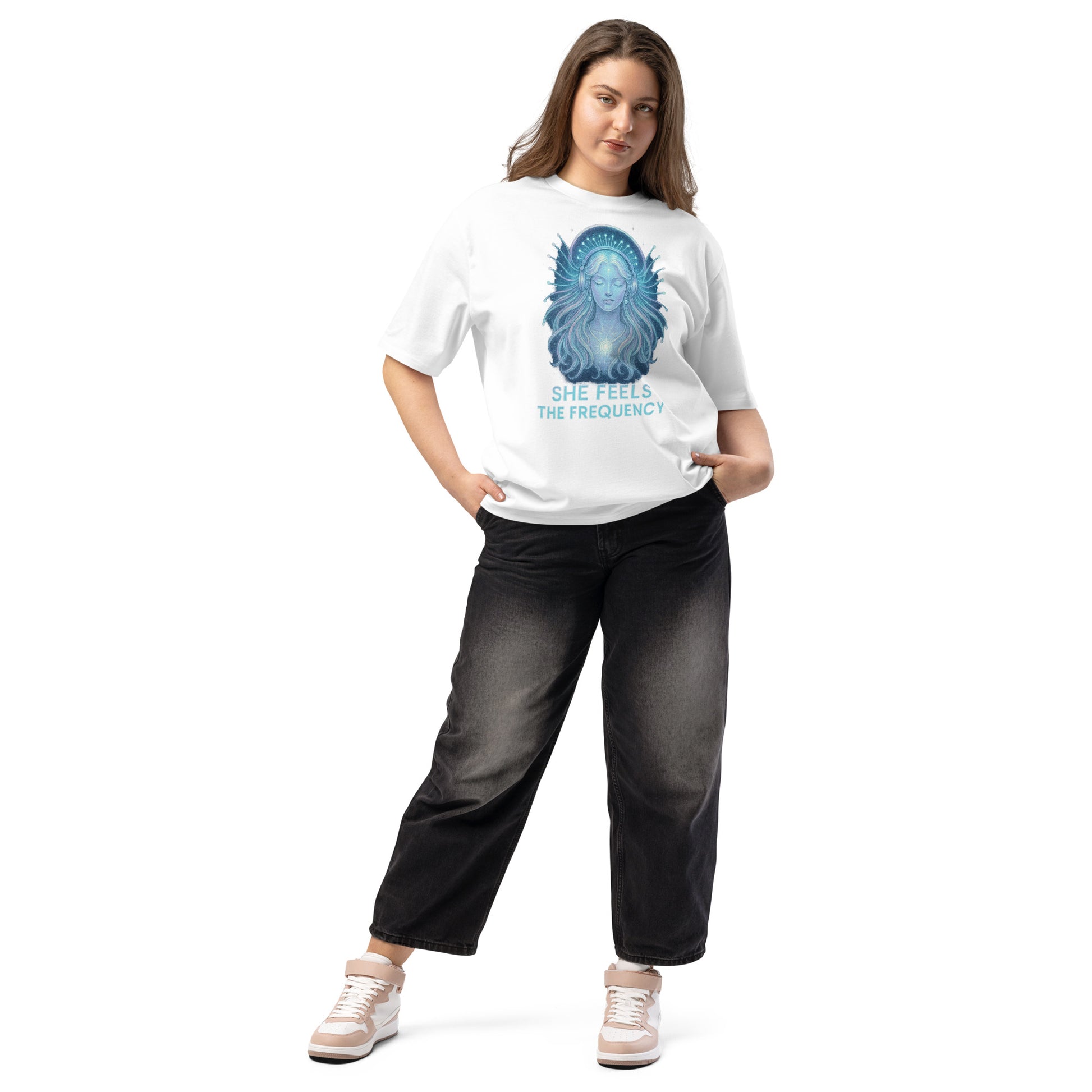 Woman wearing a white oversized t-shirt with a celestial graphic and spiritual energy theme – feminine and powerful streetwear