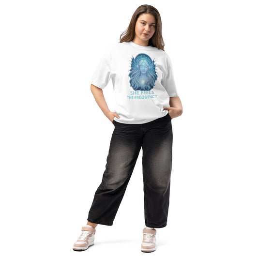 Woman wearing a white oversized t-shirt with a celestial graphic and spiritual energy theme – feminine and powerful streetwear