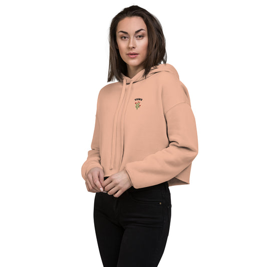Woman wearing blush pink YHWH embroidered Christian crop hoodie with floral accents
